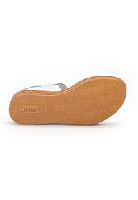 White sandal with a textured brown rubber sole, featuring dual straps and a cushioned footbed. Gabor logo embossed on the sole.