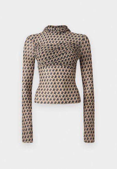 Long-sleeve top made from sheer material with a beige base and black abstract pattern, featuring a ruched design at the chest and high neckline.