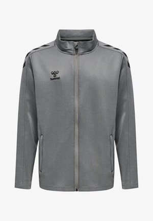 Grijze ritssluiting jack, heeft een hoge kraag, twee zijzakken en zwarte accenten op de schouders. Gemaakt van een zachte, gestructureerde stof.