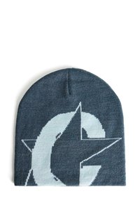 Beanie lavorato a maglia di colore blu scuro con un grande logo bianco che presenta una lettera "C" stilizzata e un motivo a stelle. Texture morbida, forma aderente.