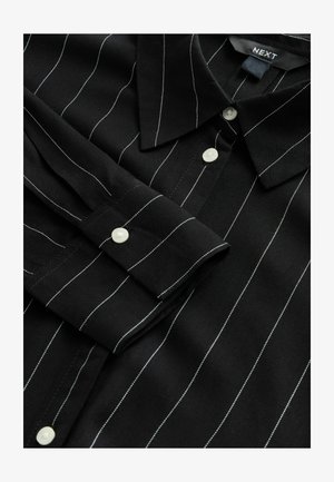 Black shirt with white pinstripes, featuring a pointed collar, long sleeves, and button closures. Soft, smooth fabric with a structured design.