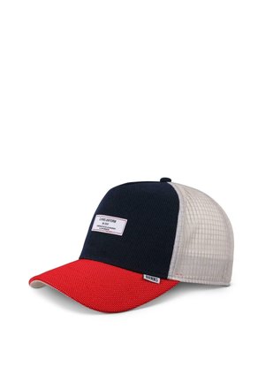 Cap with a navy blue body, red brim, and mesh beige back. Features a rectangular label on the front with black text. Textured fabric.