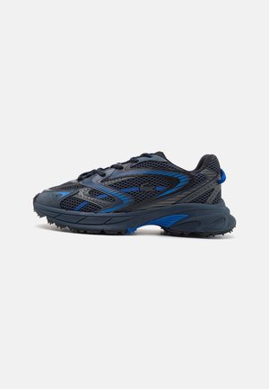 Dark blue and black athletic sneaker with mesh upper, lace-up closure, textured sole, and subtle logo on the side.