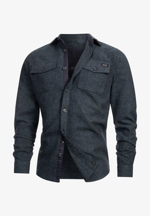 Men's dark blue flannel shirt featuring a button-up front, two chest pockets, and a contrasting inner collar. Textured fabric with a subtle pattern.
