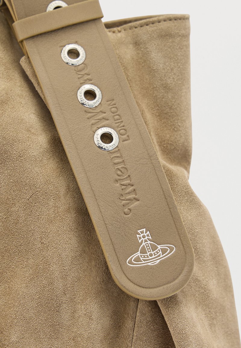 Tan leather strap with metal eyelets embossed with "Vivienne Westwood London" and a white orb logo resting on tan suede material.