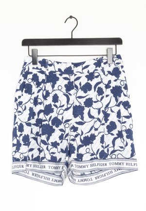 Blomstrede shorts i marineblå og hvid. Har et blomsterprint med blå accenter. Elastisk taljebånd med "TOMMY HILFIGER"-branding ved kanten.