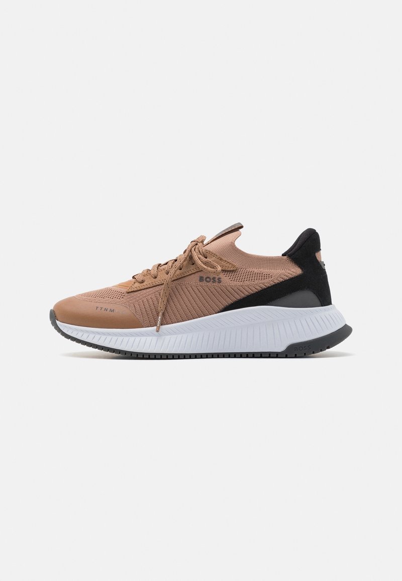 Baskets tricotées marron clair et noires avec semelle blanche rainurée, fermeture à lacets à l'avant et logo "BOSS" sur le côté et le talon.