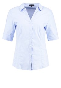 Chemise bleu clair à manches courtes, boutonnée, avec col et coupe ajustée, présentée sur fond blanc.