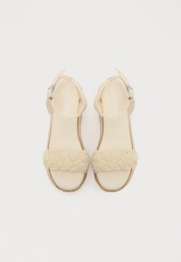 Beige espadrillesandaler med flettet tekstilrem, åpen tå, ankelrem med sølvspenne og naturlig tau såle.