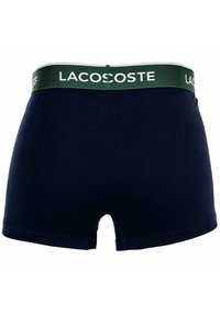Boxer in cotone per uomo di colore blu navy con elastico verde scuro, con il logo bianco di Lacoste.