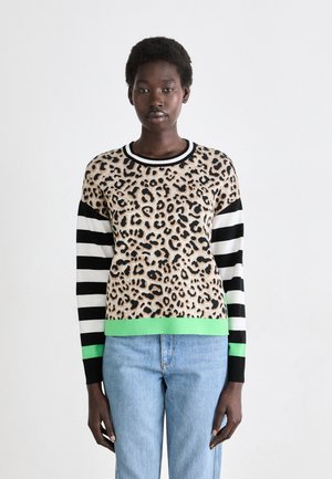 Knit sweater featuring a leopard print body, black and white striped sleeves, and a green accent at the hem. Crafted from soft fabric.