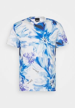 Short-sleeve cotton t-shirt featuring a blue floral print on a white background, with a crew neckline and subtle logo detail at the hem.