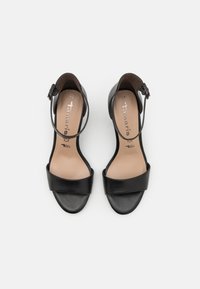 Black leather high-heeled sandals with a wide front strap and an ankle strap, featuring a smooth finish and cushioned insole. Size 37.