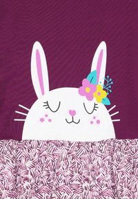 Bela zajčja obraza s rožnatimi poudarki in cvetjem na strukturirani vijolični ozadju, ki vključuje gubano spodnjo sekcijo z rožnatim vzorcem.