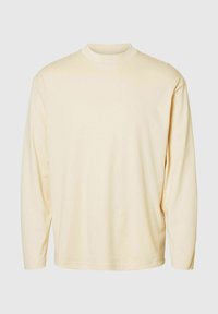 Majica z dolgimi rokavi in okroglim izrezom v svetlo rumeni barvi, izdelana iz mehkega materiala, z udobnim krojem in enostavnim dizajnom brez vzorcev ali dodatkov.