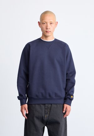Sweatshirt bleu marine en mélange de coton, avec des poignets et un ourlet côtelés, un col rond et un petit logo brodé sur la manche gauche.