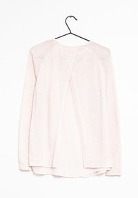 Light pink long-sleeve shirt with a cropped back and a split design. Made from soft, textured fabric, featuring a round neckline and long sleeves.