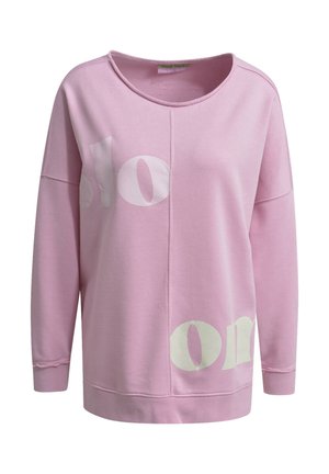 Pink sweatshirt with long sleeves, round neck, and large white text print. Soft fabric with a relaxed fit and visible stitching accents.