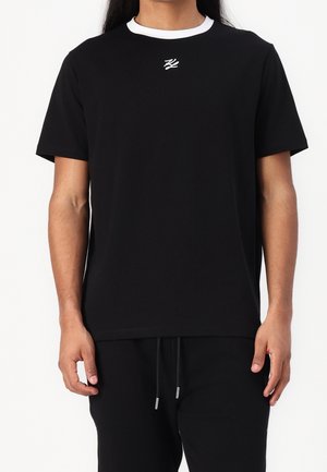 Zwart T-shirt met korte mouwen, een witte ronde hals en een klein wit logo op de borst. Zachte stof, ontspannen pasvorm.