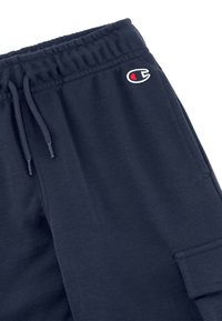 Middengrijze joggingbroek van een zachte katoenmix, met een elastische tailleband met trekkoord, zijzakken en een klein logo patch.