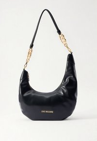 Black leather hobo bag with a smooth texture, gold-tone chain accents, and a gold logo plate at the front. Features a zip closure.