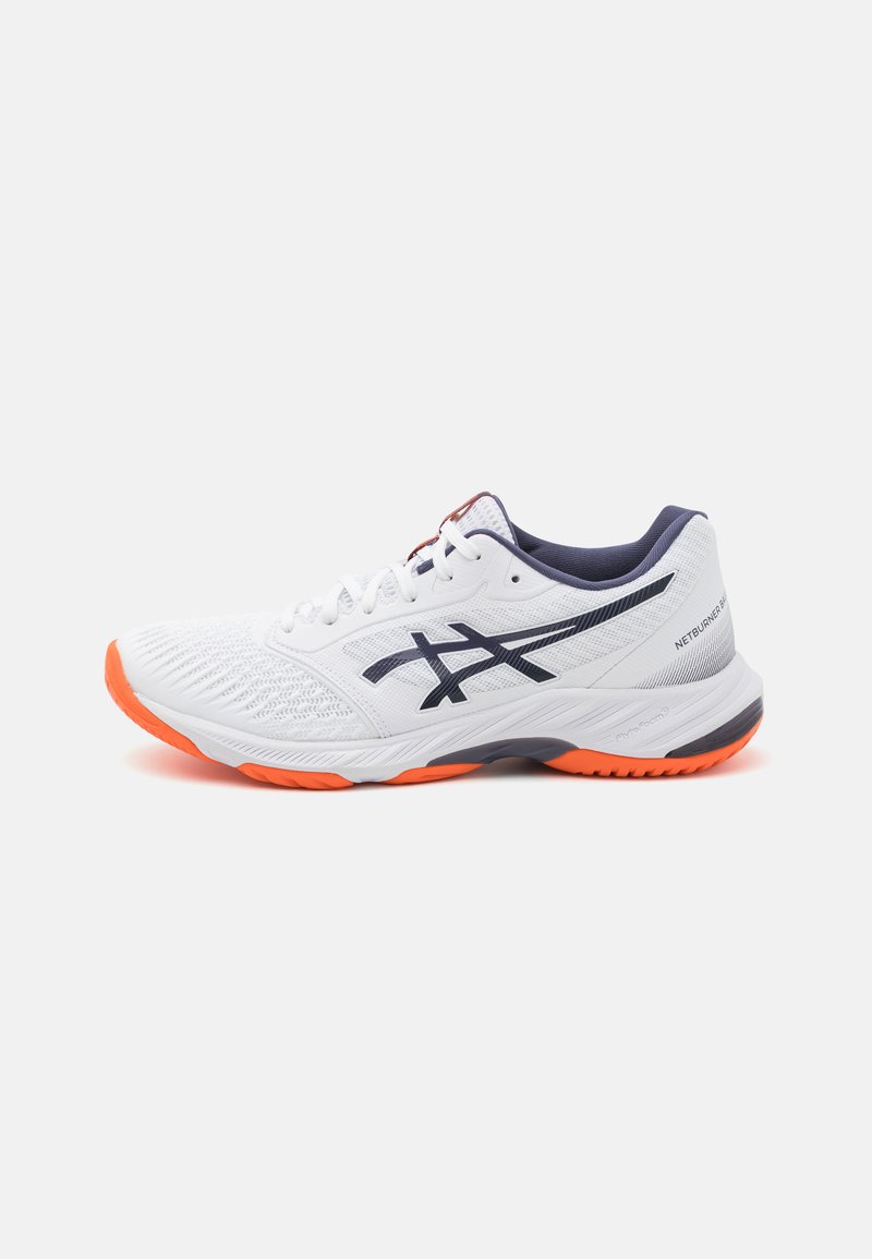 Zapatilla deportiva blanca con parte superior de malla texturizada, acentos en azul marino, suela naranja y detalle de logotipo negro en contraste en el lateral.