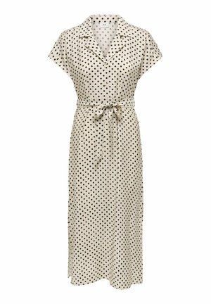 Robe midi couleur crème à pois noirs, manches courtes, col, boutonnage devant et ceinture nouée à la taille.