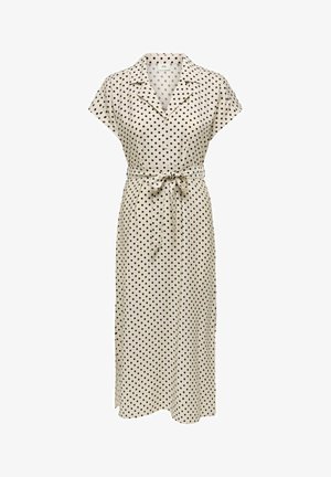Robe midi couleur crème à pois noirs, manches courtes, col, boutonnage devant et ceinture nouée à la taille.