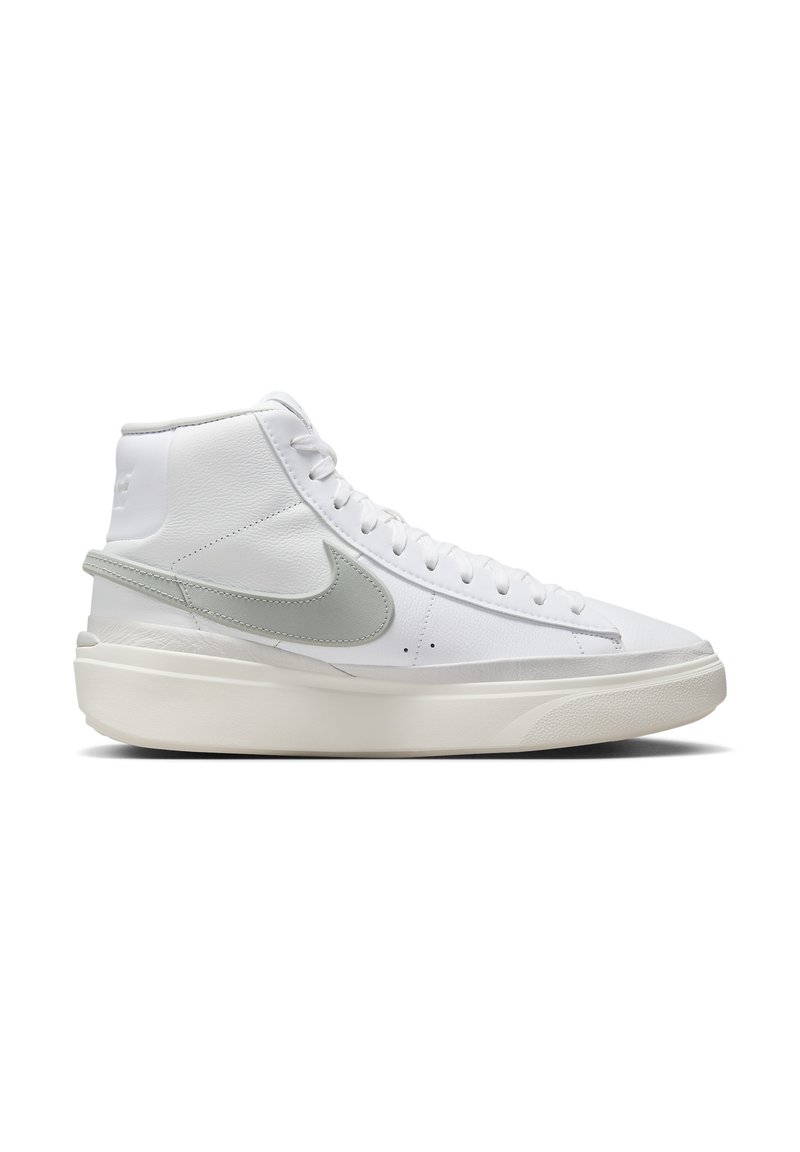 Sneaker alta bianca in pelle texturizzata, con swoosh grigio chiaro, lacci piatti e una suola bianca spessa. Nessun motivo o accento visibile.
