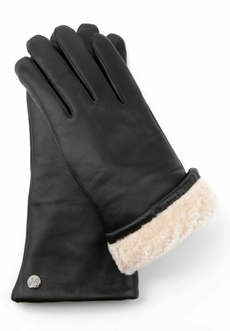 Black leather gloves with beige fur cuff. Features include seam detailing and a metal logo accent near the cuff. Smooth texture overall.