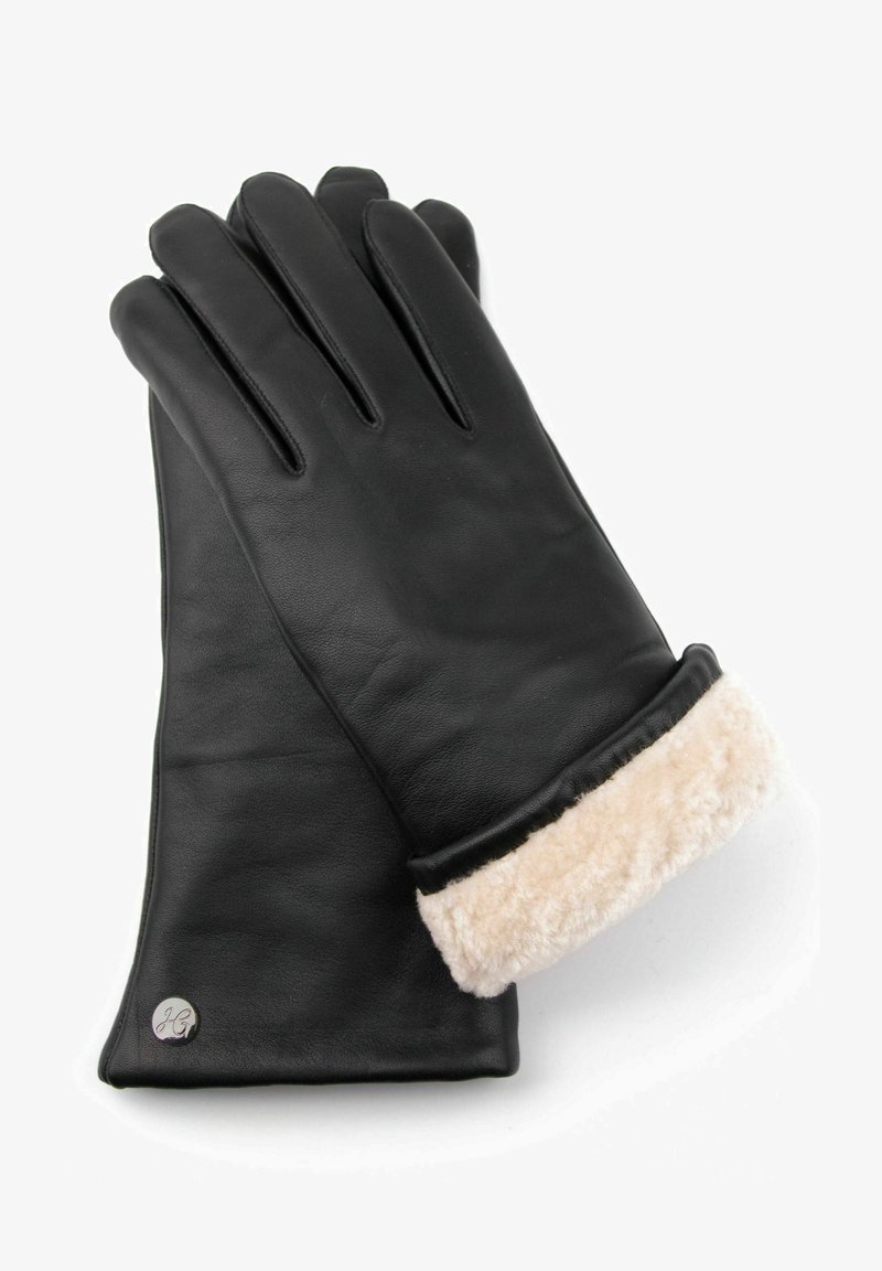 Black leather gloves with beige fur cuff. Features include seam detailing and a metal logo accent near the cuff. Smooth texture overall.