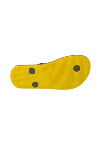 Suola di scarpa in gomma di colore giallo, con una texture rigata e puntini neri di accento. Include dettagli in rilievo per migliorare la presa e il branding.