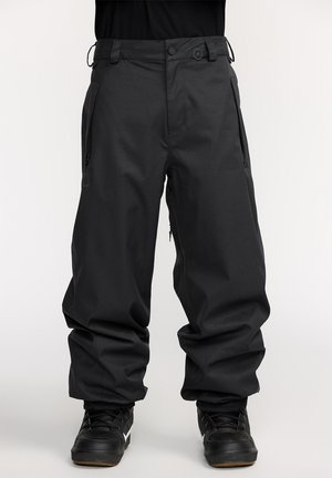 Pantalons de neige noirs avec une coupe ample, fabriqués en tissu durable. Comprend des poches zippées et des poignets élastiques aux chevilles.
