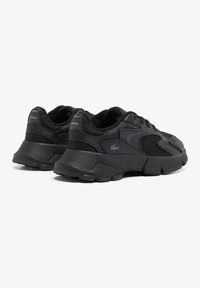 Black athletic shoes featuring a combination of smooth synthetic material and mesh. Designed with a thick sole and subtle branding details.