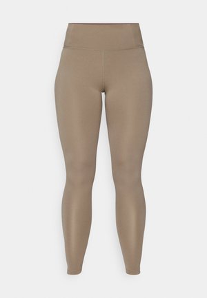 High-waisted leggings in a solid beige color. Made from a smooth, stretchy material with no visible patterns or hardware.