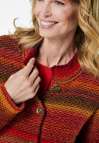 Strickcardigan in einem Farbverlauf von Rot, Orange und Braun. Verfügt über einen runden Kragen, zwei Knöpfe und strukturierte Nähte.