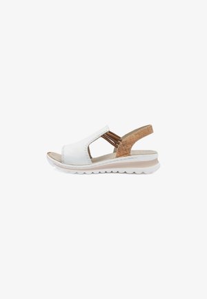 White leather sandal featuring a cork back accent, open sides, and a lightweight white sole with a soft texture and subtle sheen.