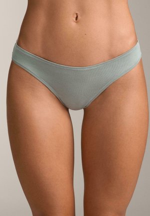 Svetlozelené plavkové nohavičky s jemnou textúrou, nízkym pásom a tenkým elastickým pásom. Na okrajoch sú viditeľné švové detaily.