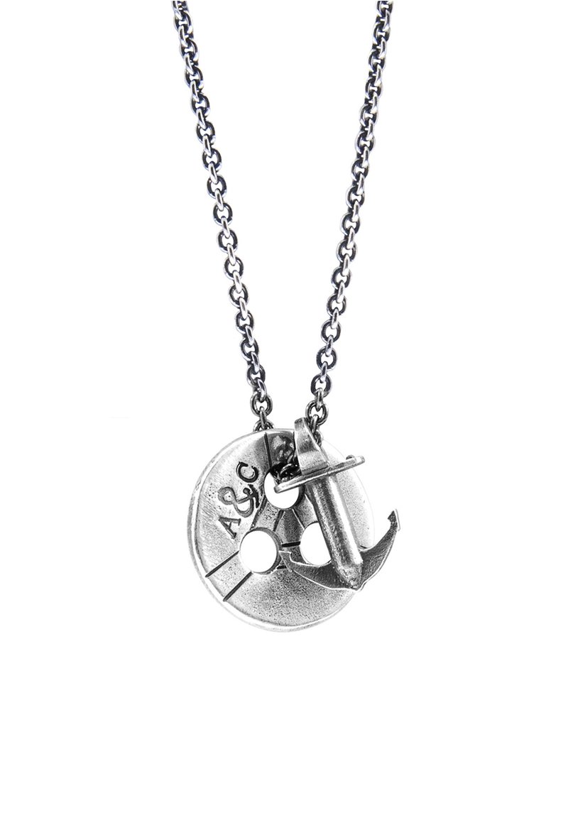 Silver-tone necklace featuring a circular pendant with two holes, engraved markings, and an anchor charm attached to the pendant.