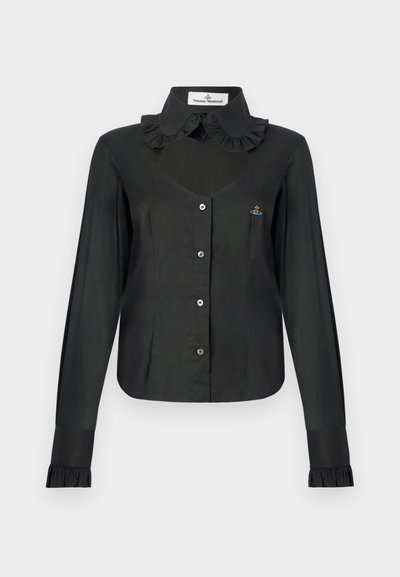 Melna blūze ar garām piedurknēm, volānu apkakli, pogu priekšpusi un piegulošu siluetu. Krūtīs neliels izšūts ornaments.