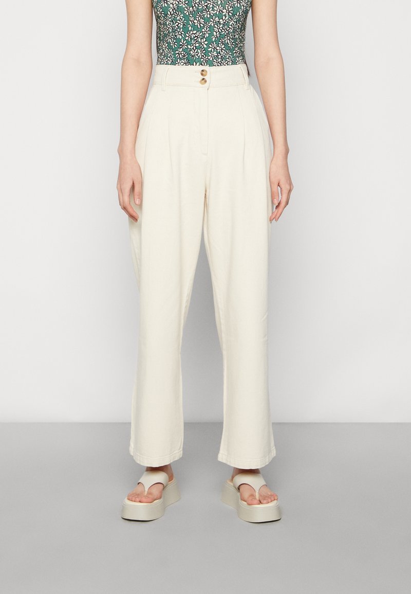 Crème-kleurige wijde broek met een hoge taille, voorzien van een dubbele knoopsluiting, zachte textuur en minimalistisch ontwerp.