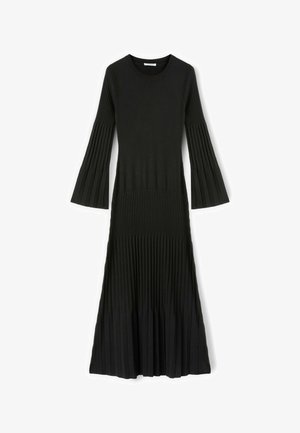 Černé pletené šaty s dlouhými nařasenými rukávy a nařasenou sukní. Mají kulatý výstřih a přiléhavý korzet.