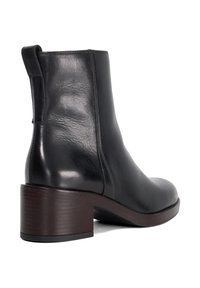 Black leather ankle boot with a rounded toe, low block heel, and pull tab; smooth texture.