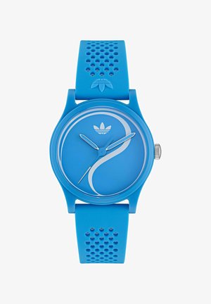 Orologio in silicone blu con quadrante rotondo e liscia. Caratterizzato da un design minimalista, lancette delle ore e dei minuti in argento e dettagli testurizzati sul cinturino.