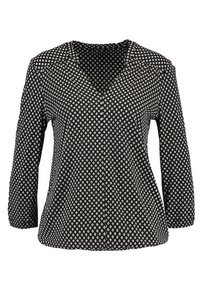 Schwarze Bluse mit weißem Diamantmuster, V-Ausschnitt und drei Viertelärmeln.
