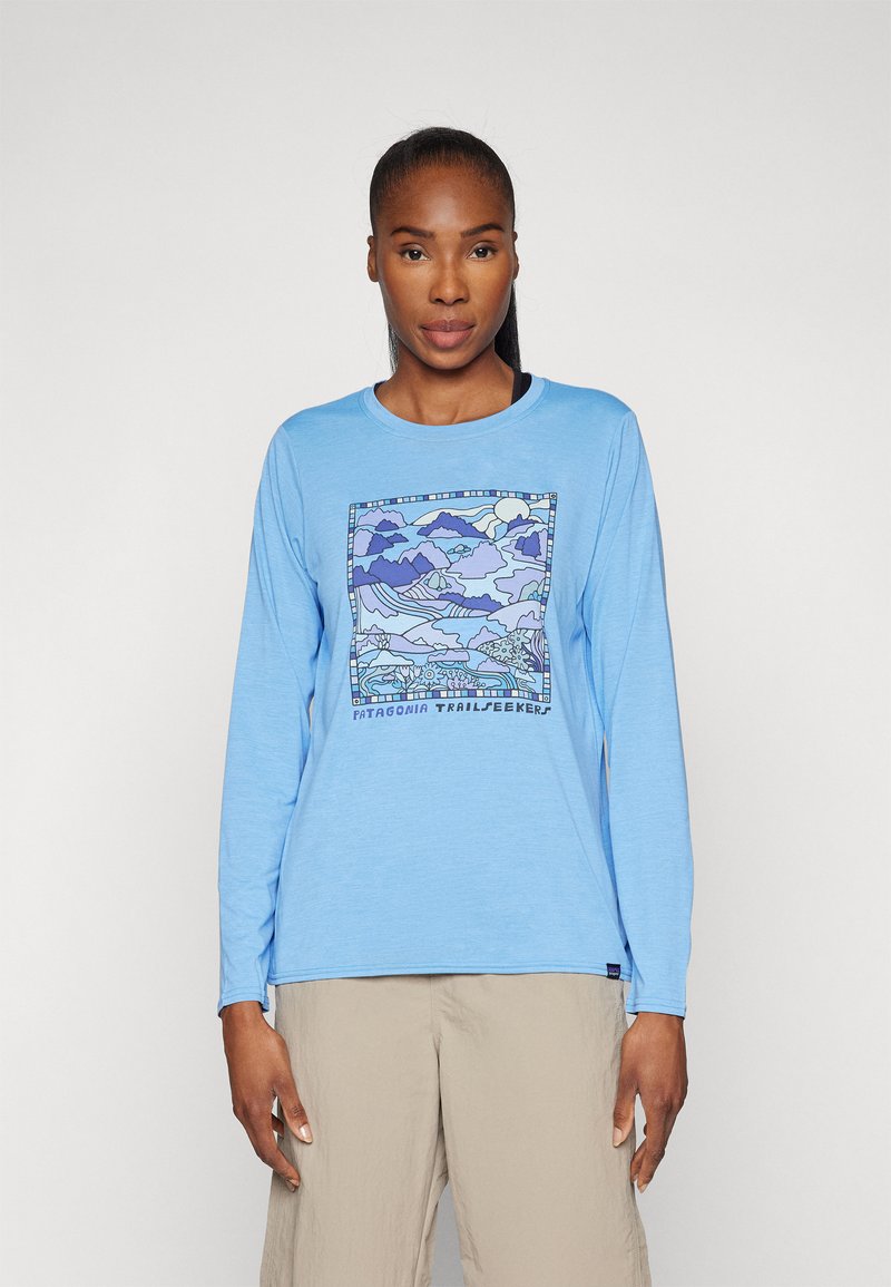 Long-sleeve blue T-shirt featuring a graphic landscape print in shades of purple and blue, with "Patagonia Trailseekers" text at the bottom.