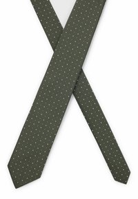 Groene stropdas met een gestructureerd oppervlak, gekenmerkt door een herhaald patroon van kleine witte vierkantjes, taps toelopende uiteinden en een standaard breedte.