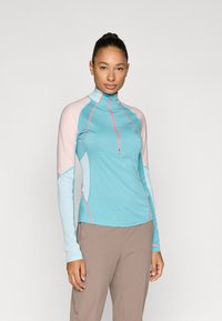 Ελαφρύ μπλουζάκι μακρυμάνικο σε τιρκουάζ χρώμα με ανοιχτό ροζ και μπλε λεπτομέρειες, με φερμουάρ στο λαιμό και αντίθετες ραφές.