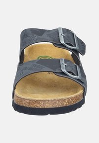 Black two-strap sandal with silver buckles, cork footbed, textured insole, and printed upper featuring newspaper-style graphics.