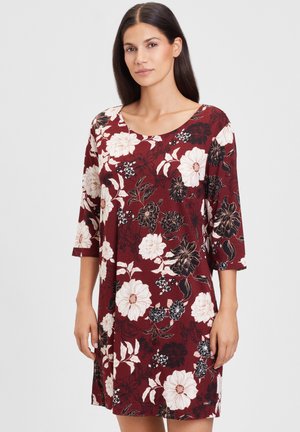 Maroon floral dress with three-quarter sleeves; features large cream and black flowers and green leaves; made of soft, textured fabric.